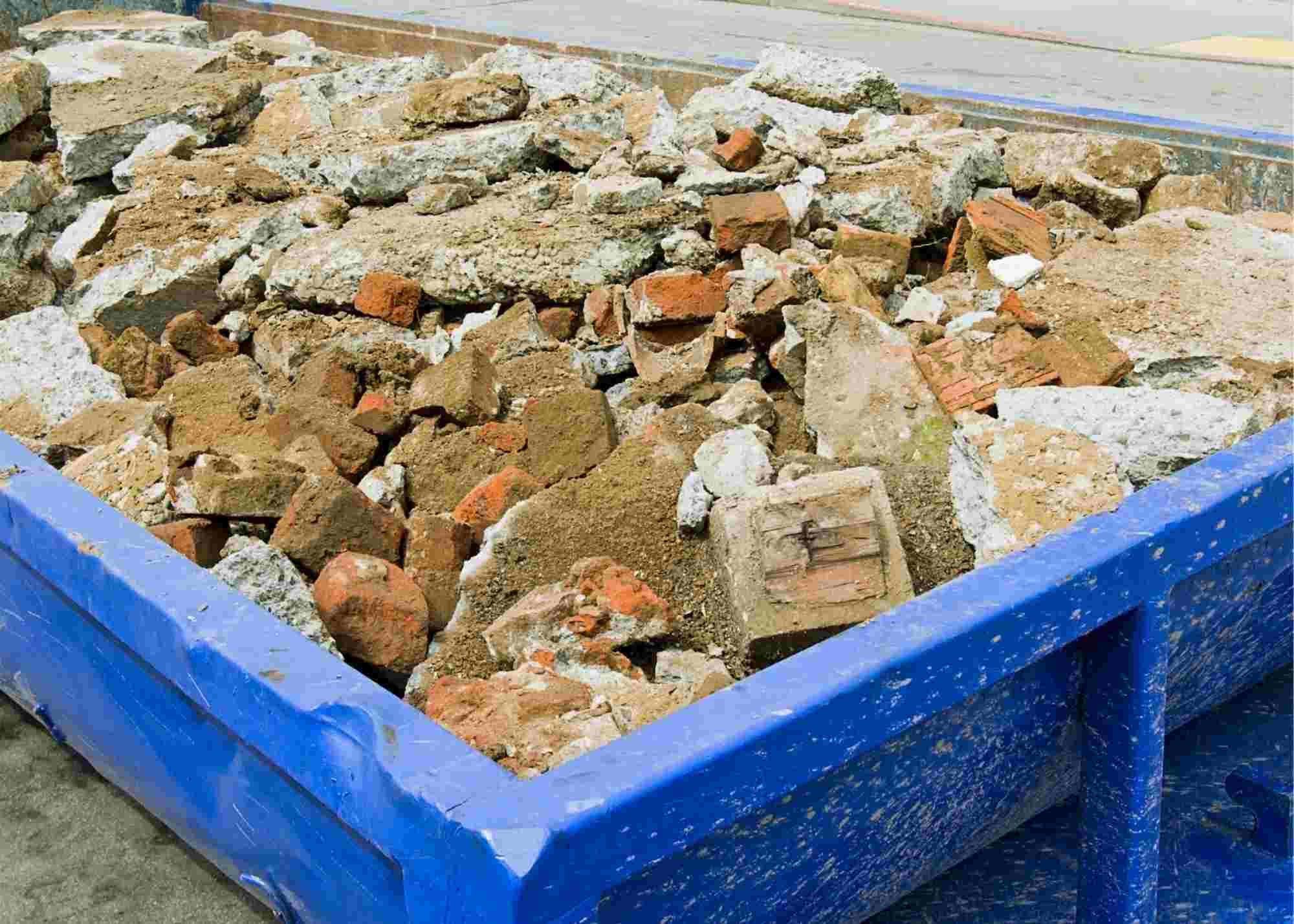 Construction Dumpster Rental Brooklyn services are one of the most in demand services from our customers. On this image you see a dumpster full of concrete debris and ready to be hauled away by our construction dumpster rental Brooklyn drivers. On this image you see a 30 yard dumpster filled with concrete and the image was taken in February 2021